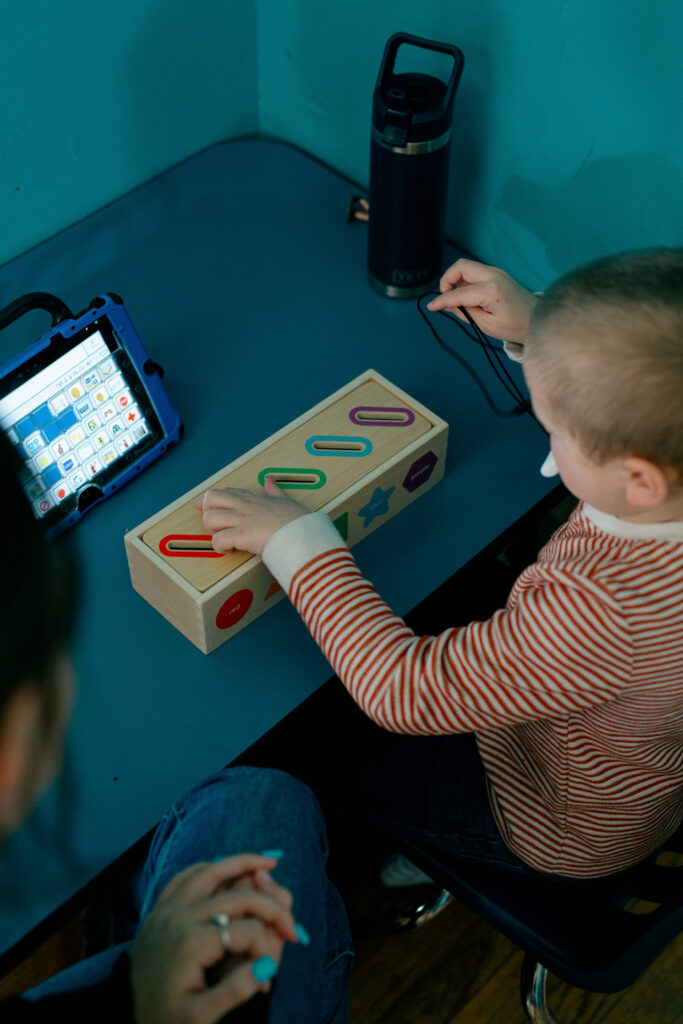 Child using iPad and blocks during activity at the Spiritos School - a leading special education school in Virginia