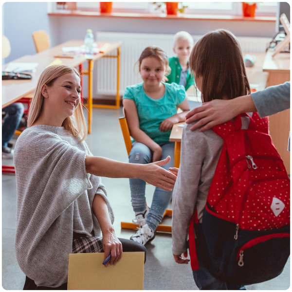 Teacher shaking hand with female student practicing skills and integrated services