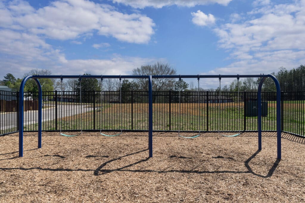 swing set on outdoor playground at Spiritos School